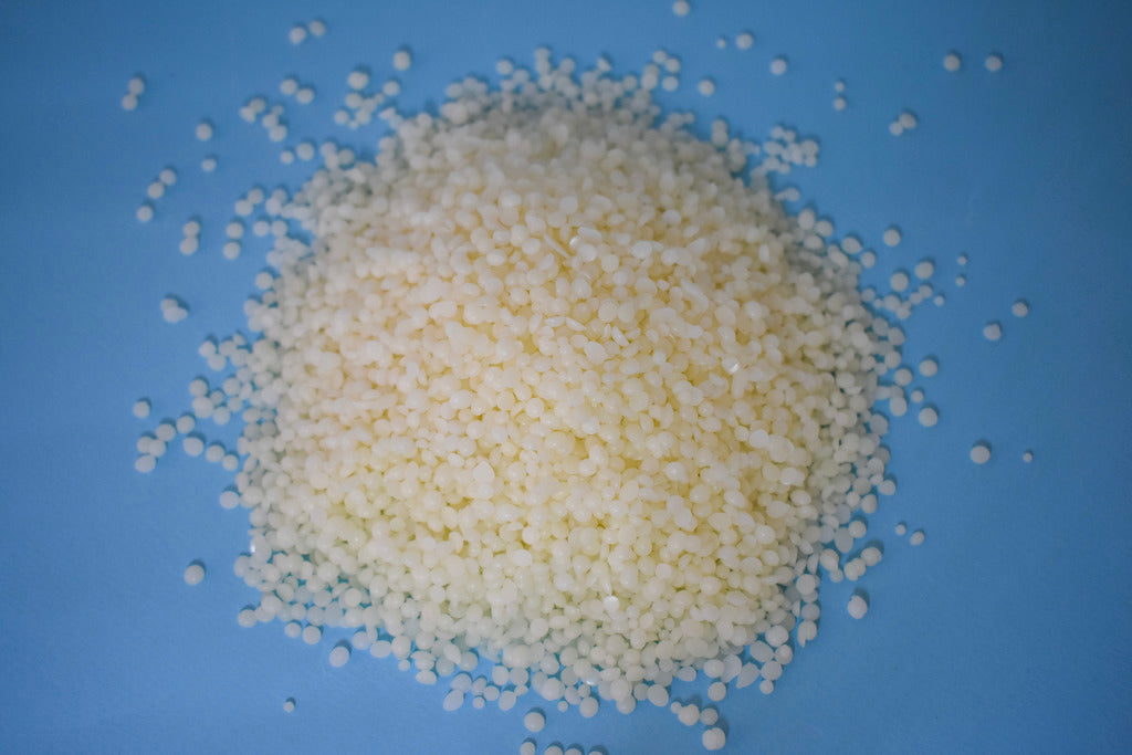 top view of white bees wax with blue background