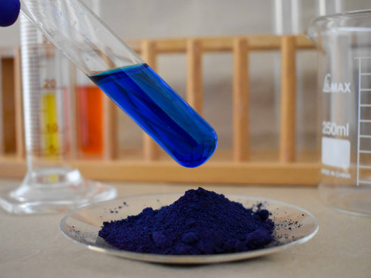 liquid and powder blue food dye in glassware