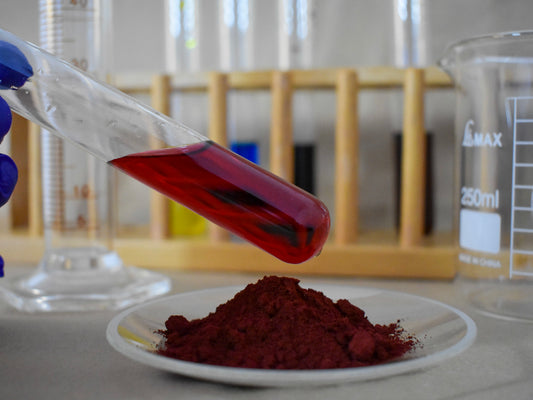 liquid and powder berry food dye in glassware