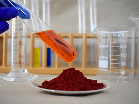 liquid and powder orange food dye in glassware