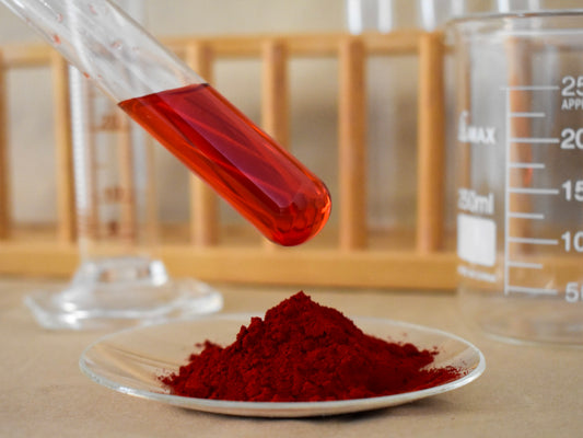 liquid and powder red food dye in glassware