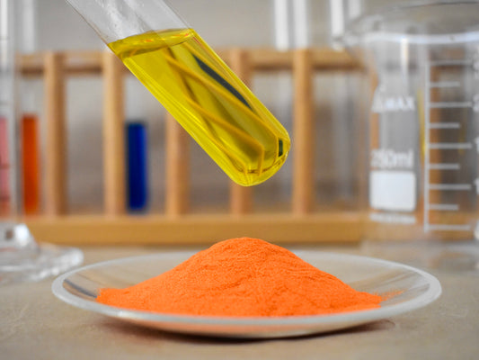 liquid and powder yellow food dye in glassware